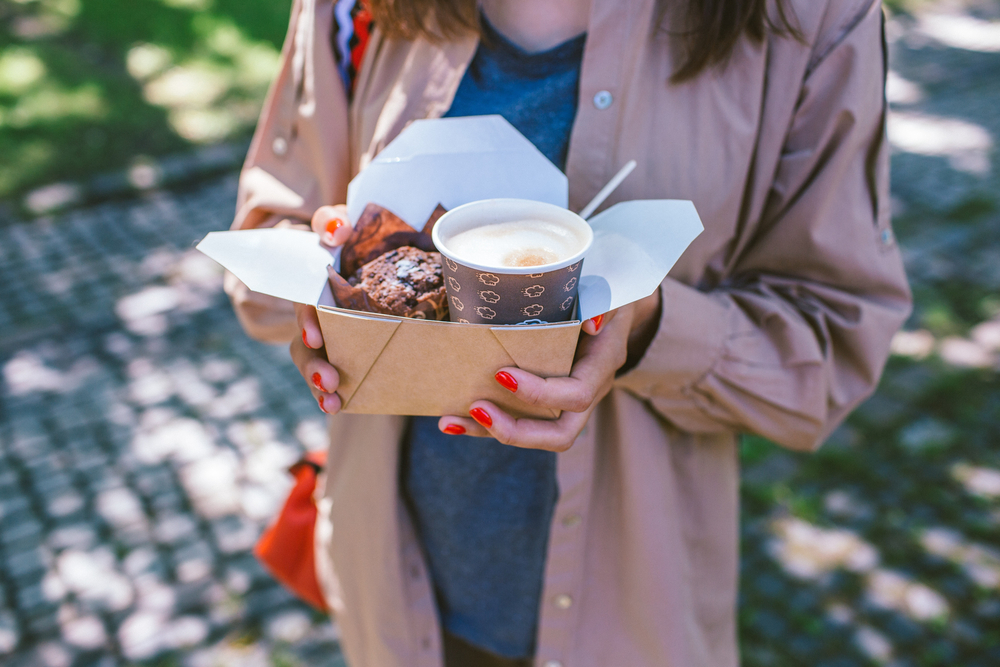 Woman with takeaway breakfast box